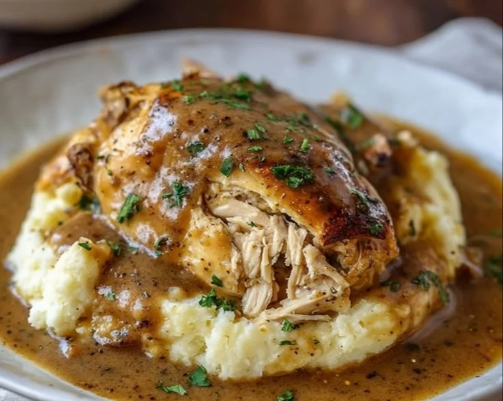 Delicious Crockpot Chicken and Gravy served with mashed potatoes.