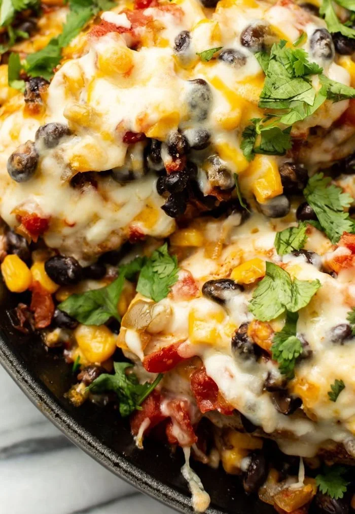 Plate of Santa Fe Chicken garnished with vegetables and spices