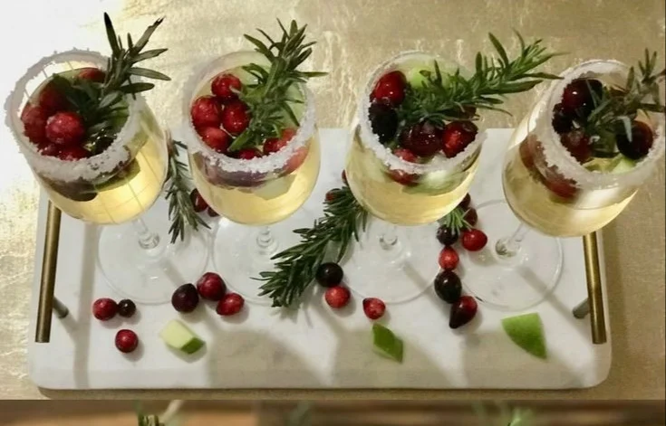 A festive Christmas Sangria served in a glass with fruit garnishes.