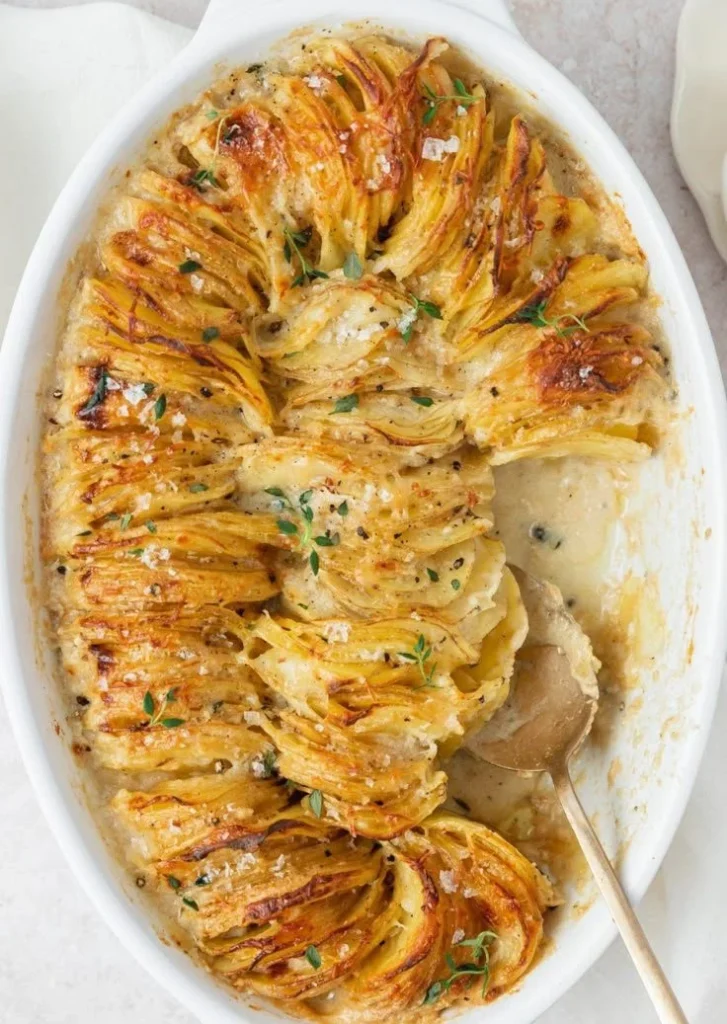 Creamy scalloped potatoes topped with cheese and herbs, a delicious side dish.