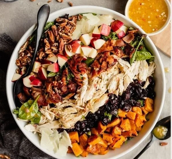 Colorful fall harvest salad with seasonal vegetables and fruits