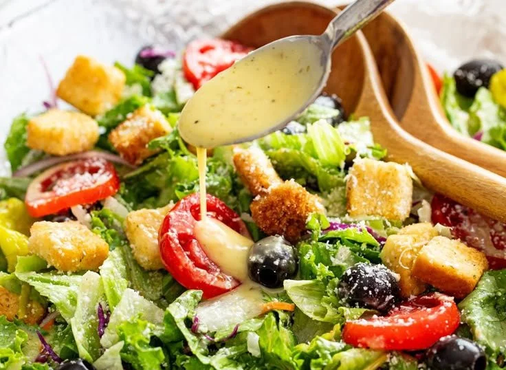 Delicious Olive Garden Salad with fresh greens, tomatoes, and olives