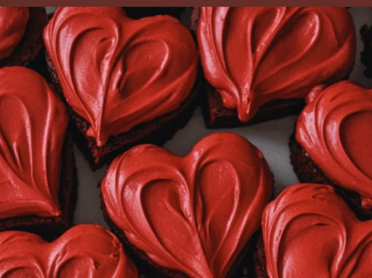 Delicious heart-shaped brownies decorated with chocolate drizzle and sprinkles.