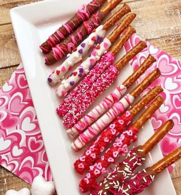 Valentine's Day chocolate dipped pretzels decorated with pink sprinkles