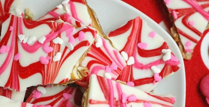 Valentine's Day Crack recipe with chocolate, nuts, and festive sprinkles.